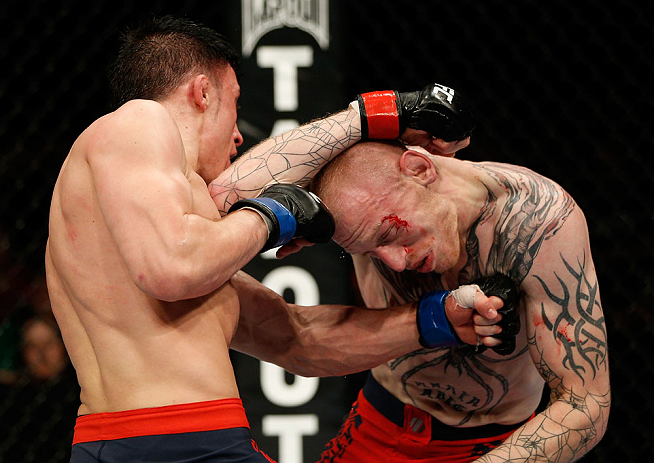 GOLD COAST, AUSTRALIA - DECEMBER 15:  (L-R) Norman Parke punches Colin Fletcher during their lightweight fight at the UFC on FX event on December 15, 2012  at Gold Coast Convention and Exhibition Centre in Gold Coast, Australia.  (Photo by Josh Hedges/Zuf