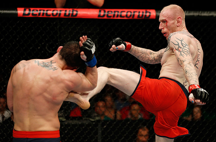GOLD COAST, AUSTRALIA - DECEMBER 15:  (R-L) Colin Fletcher kicks Norman Parke during their lightweight fight at the UFC on FX event on December 15, 2012  at Gold Coast Convention and Exhibition Centre in Gold Coast, Australia.  (Photo by Josh Hedges/Zuffa