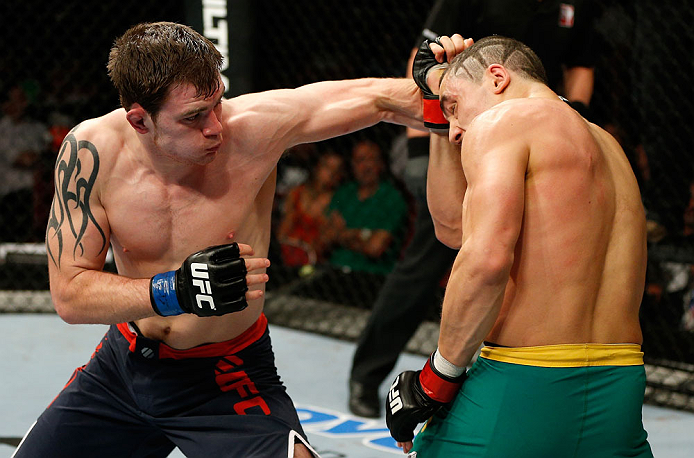 GOLD COAST, AUSTRALIA - DECEMBER 15:  (L-R) Bradley Scott punches Robert Whittaker during their welterweight fight at the UFC on FX event on December 15, 2012  at Gold Coast Convention and Exhibition Centre in Gold Coast, Australia.  (Photo by Josh Hedges