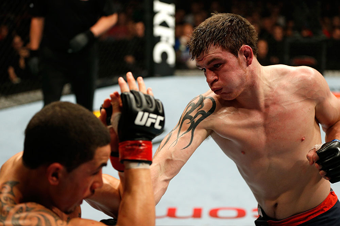 GOLD COAST, AUSTRALIA - DECEMBER 15:  (R-L) Bradley Scott punches Robert Whittaker during their welterweight fight at the UFC on FX event on December 15, 2012  at Gold Coast Convention and Exhibition Centre in Gold Coast, Australia.  (Photo by Josh Hedges