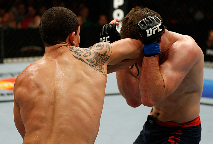 GOLD COAST, AUSTRALIA - DECEMBER 15:  (L-R) Robert Whittaker elbows Bradley Scott during their welterweight fight at the UFC on FX event on December 15, 2012  at Gold Coast Convention and Exhibition Centre in Gold Coast, Australia.  (Photo by Josh Hedges/
