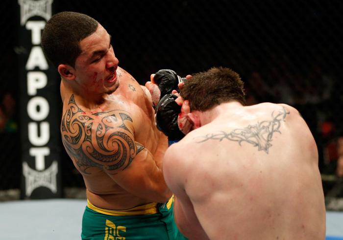 GOLD COAST, AUSTRALIA - DECEMBER 15:  (L-R) Robert Whittaker punches Bradley Scott during their welterweight fight at the UFC on FX event on December 15, 2012  at Gold Coast Convention and Exhibition Centre in Gold Coast, Australia.  (Photo by Josh Hedges