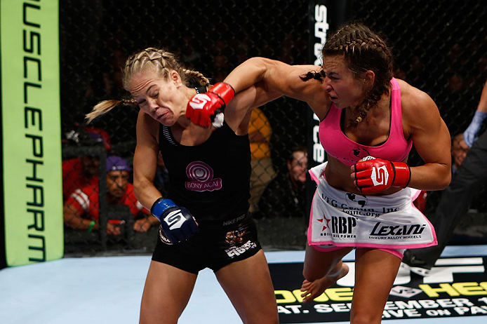 SAN DIEGO, CA - AUGUST 18: (R-L) Miesha Tate punches Julie Kedzie during the Strikeforce event at Valley View Casino Center on August 18, 2012 in San Diego, California. (Photo by Esther Lin/Forza LLC/Forza LLC via Getty Images)