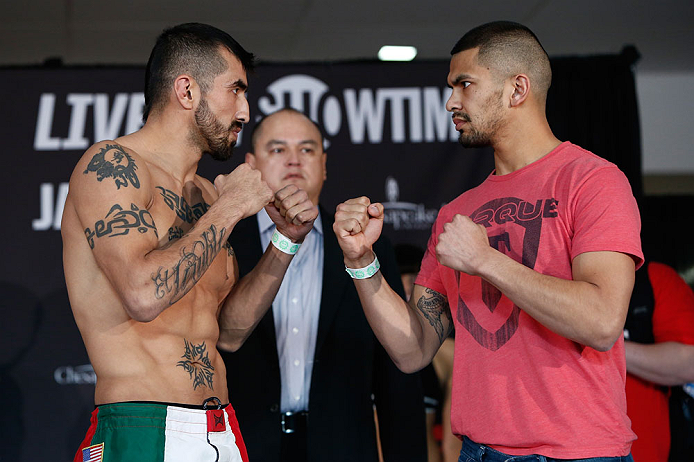 OKLAHOMA CITY, OK - JANUARY 11:  (L-R) Opponents Estevan Payan and Michael Bravo face off during the Strikeforce weigh-in event on January 11, 2013 at Chesapeake Energy Arena in Oklahoma City, Oklahoma. (Photo by Esther Lin/Forza LLC/Forza LLC via Getty I