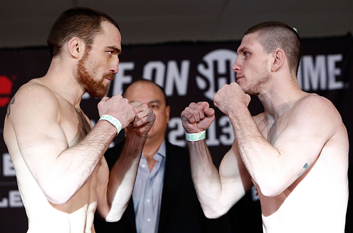 OKLAHOMA CITY, OK - JANUARY 11:  (L-R) Opponents Pat Healy and Kurt Holobaugh face off during the Strikeforce weigh-in event on January 11, 2013 at Chesapeake Energy Arena in Oklahoma City, Oklahoma. (Photo by Esther Lin/Forza LLC/Forza LLC via Getty Imag