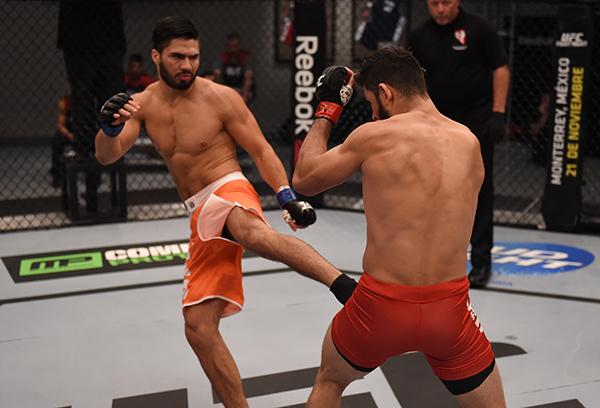 LAS VEGAS, NV - APRIL 21: (L-R) Horacio Gutrierrez kicks Polo Reyes in their semi-finals fight during the filming of The Ultimate Fighter Latin America: Team Gastelum vs Team Escudero on April 21, 2015 in Las Vegas, Nevada. (Photo by Brandon Magnus/Zuffa