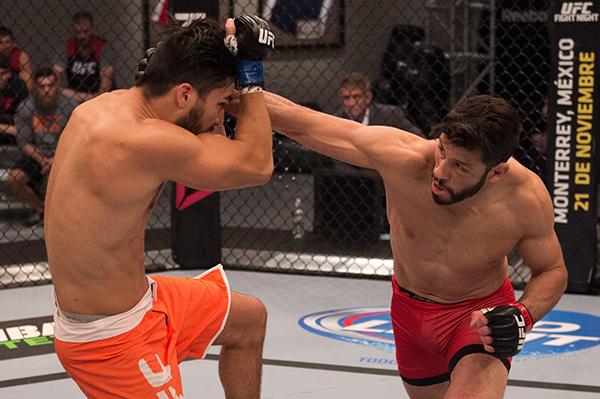 LAS VEGAS, NV - APRIL 21: (R-L) Polo Reyes punches Horacio Gutrierrez in their semi-finals fight during the filming of The Ultimate Fighter Latin America: Team Gastelum vs Team Escudero on April 21, 2015 in Las Vegas, Nevada. (Photo by Brandon Magnus/Zu
