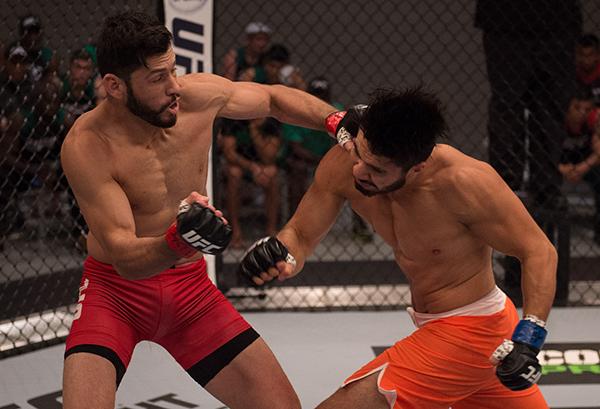 LAS VEGAS, NV - APRIL 21: (R-L) Horacio Gutrierrez punches Polo Reyes in their semi-finals fight during the filming of The Ultimate Fighter Latin America: Team Gastelum vs Team Escudero on April 21, 2015 in Las Vegas, Nevada. (Photo by Brandon Magnus/Zuf