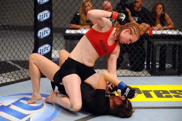 LAS VEGAS, NV - MAY 29:  Peggy Morgan (top) punches Bethany Marshall in their elimination fight during filming of season eighteen of The Ultimate Fighter on May 29, 2013 in Las Vegas, Nevada. (Photo by Al Powers/Zuffa LLC/Zuffa LLC via Getty Images) 