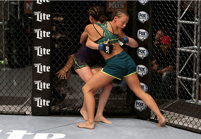 LAS VEGAS, NV - JULY 15:  (R-L) Team Pettis fighter Jessica Penne pushes team Melendez fighter Lisa Ellis up against the fence during filming of season twenty of The Ultimate Fighter on July 15, 2014 in Las Vegas, Nevada. (Photo by Brandon Magnus/Zuffa LL