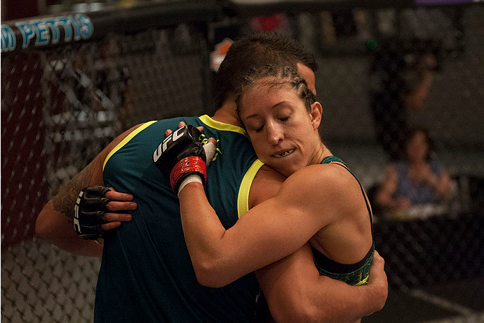 LAS VEGAS, NV - JULY 15: Team Pettis fighter Jessica Penne hugs Head Coach Anthony Pettis after defeating team Melendez fighter Lisa Ellis during filming of season twenty of The Ultimate Fighter on July 15, 2014 in Las Vegas, Nevada. (Photo by Brandon Ma