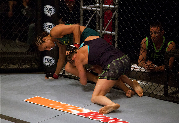 LAS VEGAS, NV - JULY 15:  (R-L) Team Melendez fighter Lisa Ellis takes down team Pettis fighter Jessica Penne during filming of season twenty of The Ultimate Fighter on July 15, 2014 in Las Vegas, Nevada. (Photo by Brandon Magnus/Zuffa LLC/Zuffa LLC via G