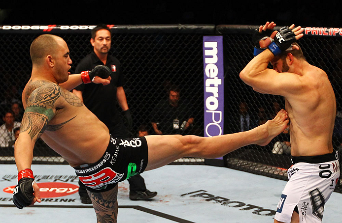 ATLANTA, GA - APRIL 21:  Travis Browne (L) kicks Chad Griggs during their heavyweight bout for UFC 145 at Philips Arena on April 21, 2012 in Atlanta, Georgia.  (Photo by Al Bello/Zuffa LLC/Zuffa LLC via Getty Images)