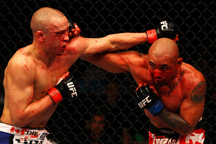 ATLANTA, GA - APRIL 21:  Eddie Yagin (R) punches Mark Hominick during their featherweight bout for UFC 145 at Philips Arena on April 21, 2012 in Atlanta, Georgia.  (Photo by Al Bello/Zuffa LLC/Zuffa LLC via Getty Images)