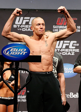 MONTREAL, QC - MARCH 15: Georges St-Pierre raises his arms during the UFC 158 weigh-in at Bell Centre on March 15, 2013 in Montreal, Quebec, Canada. (Photo by Josh Hedges/Zuffa LLC/Zuffa LLC via Getty Images)