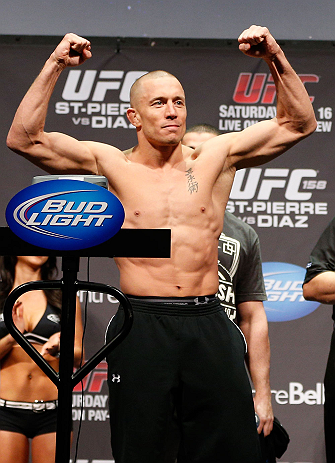 MONTREAL, QC - MARCH 15:  Georges St-Pierre raises his arms during the UFC 158 weigh-in at Bell Centre on March 15, 2013 in Montreal, Quebec, Canada.  (Photo by Josh Hedges/Zuffa LLC/Zuffa LLC via Getty Images)