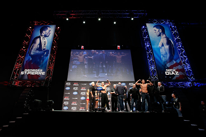 MONTREAL, QC - MARCH 15:  (L-R) Opponents Georges St-Pierre and Nick Diaz pose for the fans during the UFC 158 weigh-in at Bell Centre on March 15, 2013 in Montreal, Quebec, Canada.  (Photo by Josh Hedges/Zuffa LLC/Zuffa LLC via Getty Images)