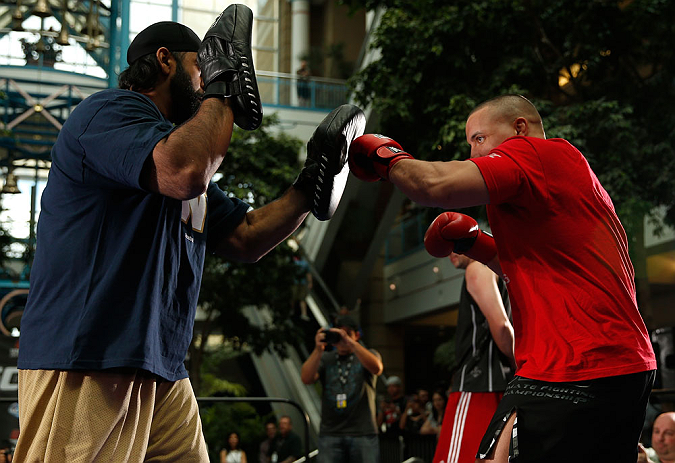 WINNIPEG, CANADA - JUNE 12: (R-L) Pat Barry works out with former CFL football player Obby Khan during an open workout session for fans and media at Portage Place on June 12, 2013 in Winnipeg, Manitoba, Canada. (Photo by Josh Hedges/Zuffa LLC/Zuffa LLC