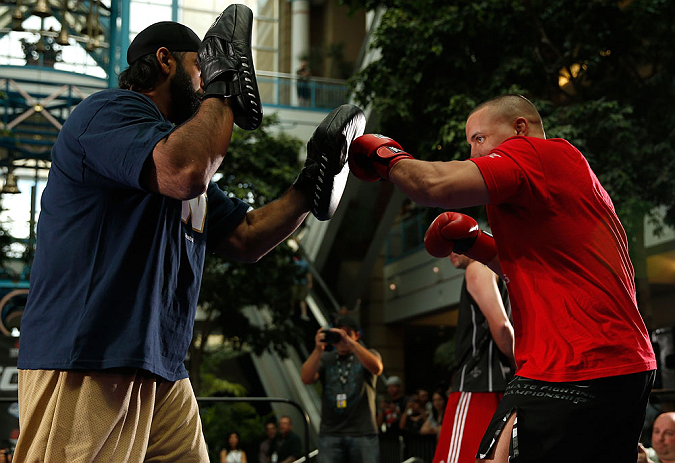 WINNIPEG, CANADA - JUNE 12:  (R-L) Pat Barry works out with former CFL football player Obby Khan during an open workout session for fans and media at Portage Place on June 12, 2013 in Winnipeg, Manitoba, Canada.  (Photo by Josh Hedges/Zuffa LLC/Zuffa LLC 