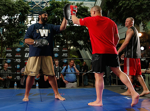 WINNIPEG, CANADA - JUNE 12: (R-L) Pat Barry works out with former CFL football player Obby Khan during an open workout session for fans and media at Portage Place on June 12, 2013 in Winnipeg, Manitoba, Canada. (Photo by Josh Hedges/Zuffa LLC/Zuffa LLC