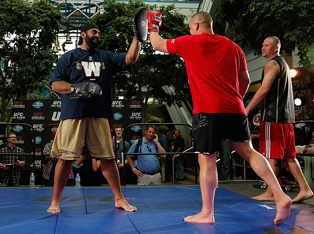 WINNIPEG, CANADA - JUNE 12:  (R-L) Pat Barry works out with former CFL football player Obby Khan during an open workout session for fans and media at Portage Place on June 12, 2013 in Winnipeg, Manitoba, Canada.  (Photo by Josh Hedges/Zuffa LLC/Zuffa LLC 