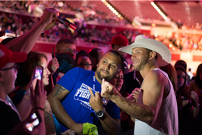 DALLAS, TX - MARCH 13: Donald "Cowboy" Cerrone takes a photo with a fan during the UFC 185 weigh-ins at the Kay Bailey Hutchison Convention Center on March 13, 2015 in Dallas, Texas. (Photo by Cooper Neill/Zuffa LLC/Zuffa LLC via Getty Images)