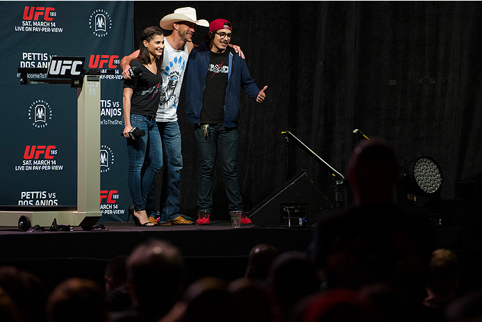 DALLAS, TX - MARCH 13: Megan Olivi and Donald "Cowboy" Cerrone pose for a photo with a fan before the UFC 185 weigh-ins at the Kay Bailey Hutchison Convention Center on March 13, 2015 in Dallas, Texas. (Photo by Cooper Neill/Zuffa LLC/Zuffa LLC via Getty