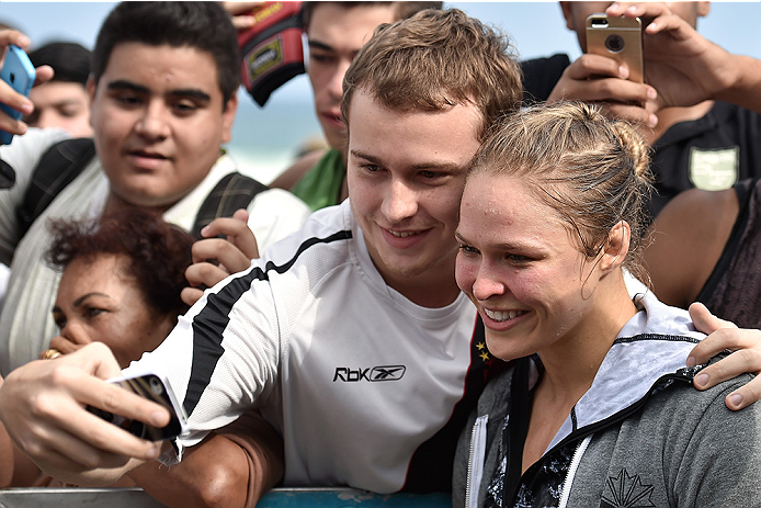 RIO DE JANEIRO, BRAZIL - JULY 29:  Womens bantamweight champion Ronda Rousey of the United States takes photos with fans during open training session at Pepe Beach on July 29, 2015 in Rio de Janeiro, Brazil.  (Photo by Buda Mendes/Zuffa LLC/Zuffa LLC via 