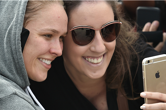 RIO DE JANEIRO, BRAZIL - JULY 29: Womens bantamweight champion Ronda Rousey of the United States takes photos with fans during open training session at Pepe Beach on July 29, 2015 in Rio de Janeiro, Brazil. (Photo by Buda Mendes/Zuffa LLC/Zuffa LLC via