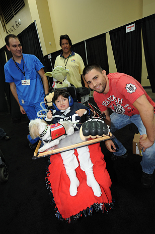 LAS VEGAS, NV - JULY 06: Carlos Condit poses with fans at the UFC Fan Expo on July 6, 2012 in Las Vegas, Nevada. (Photo by Al Powers /Zuffa LLC/Zuffa LLC via Getty Images) *** Local Caption *** Carlos Condit