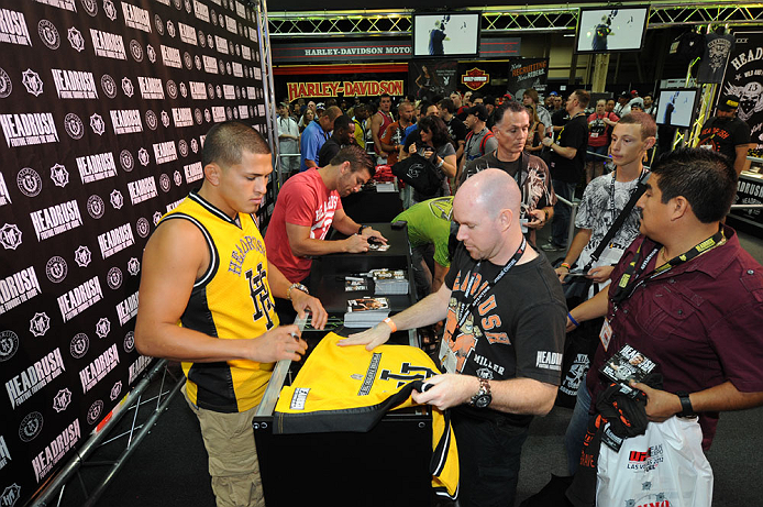 LAS VEGAS, NV - JULY 7:   Anthony Pettis and Sam Stout sign autographs during the UFC Fan Expo at the Mandalay Bay Convention Center on July 7, 2012 in Las Vegas, Nevada.  (Photo by Al Powers/Zuffa LLC/Zuffa LLC via Getty Images)  *** Local Caption *** 