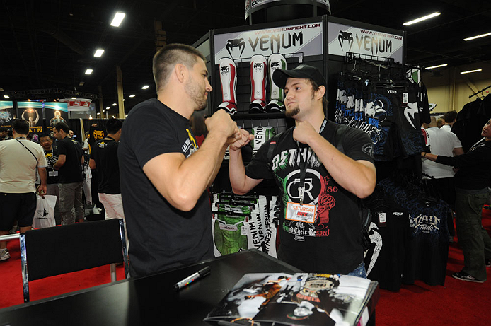 LAS VEGAS, NV - JULY 7: Carlos Condit faces off with a fan during the UFC Fan Expo at the Mandalay Bay Convention Center on July 7, 2012 in Las Vegas, Nevada. (Photo by Al Powers/Zuffa LLC/Zuffa LLC via Getty Images) *** Local Caption ***