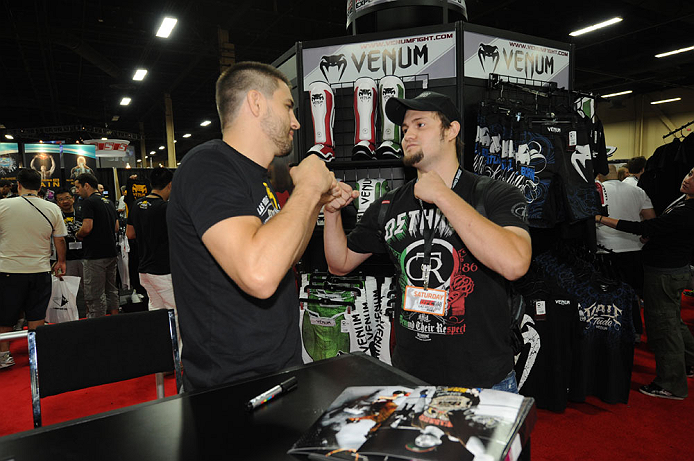 LAS VEGAS, NV - JULY 7:  Carlos Condit faces off with a fan during the UFC Fan Expo at the Mandalay Bay Convention Center on July 7, 2012 in Las Vegas, Nevada.  (Photo by Al Powers/Zuffa LLC/Zuffa LLC via Getty Images)  *** Local Caption *** 