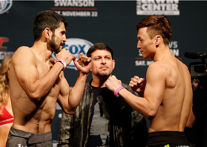 AUSTIN, TX - NOVEMBER 21:  (L-R) Opponents Juan Puig of Mexico and Doo Ho Choi of South Korea face off during the UFC weigh-in at The Frank Erwin Center on November 21, 2014 in Austin, Texas.  (Photo by Josh Hedges/Zuffa LLC/Zuffa LLC via Getty Images)