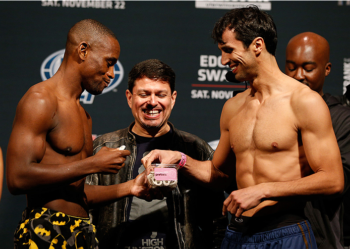 AUSTIN, TX - NOVEMBER 21:  (L-R) Opponents Yves Edwards of the Bahamas and Akbarh Arreola of Mexico share a snake after making weight during the UFC weigh-in at The Frank Erwin Center on November 21, 2014 in Austin, Texas.  (Photo by Josh Hedges/Zuffa LLC