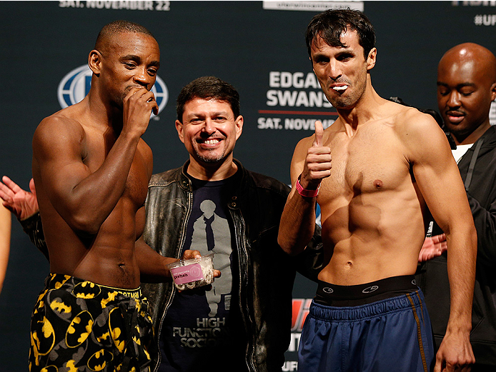 AUSTIN, TX - NOVEMBER 21:  (L-R) Opponents Yves Edwards of the Bahamas and Akbarh Arreola of Mexico share a snake after making weight during the UFC weigh-in at The Frank Erwin Center on November 21, 2014 in Austin, Texas.  (Photo by Josh Hedges/Zuffa LLC