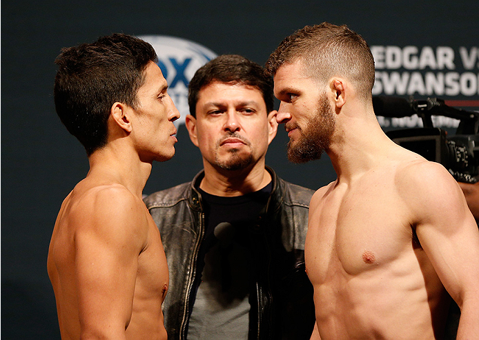 AUSTIN, TX - NOVEMBER 21:  (L-R) Opponents Joseph Benavidez and Dustin Ortiz face off during the UFC weigh-in at The Frank Erwin Center on November 21, 2014 in Austin, Texas.  (Photo by Josh Hedges/Zuffa LLC/Zuffa LLC via Getty Images)