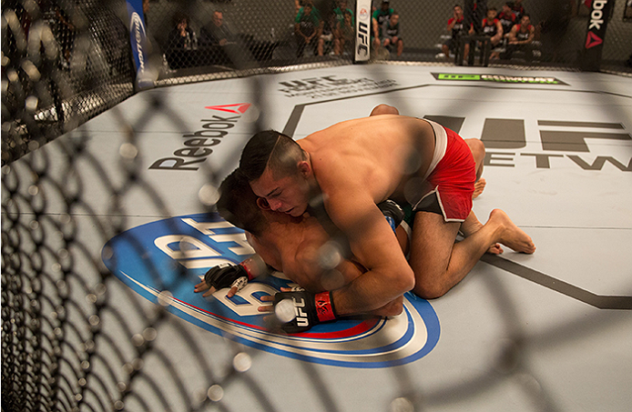 LAS VEGAS, NV - APRIL 10: Alvaro Herrera controls the body of Hector Aldana during the filming of The Ultimate Fighter Latin America: Team Gastelum vs Team Escudero on April 10, 2015 in Las Vegas, Nevada. (Photo by Brandon Magnus/Zuffa LLC/Zuffa LLC via