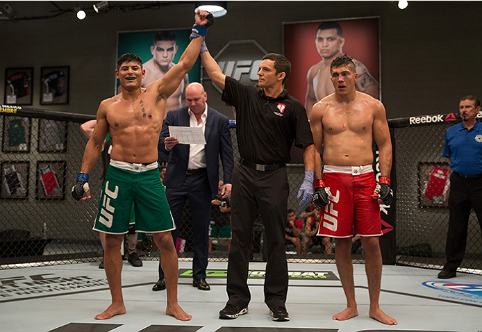 LAS VEGAS, NV - APRIL 10: (L-R) Hector Aldana celebrates his victory over Alvaro Herrera during the filming of The Ultimate Fighter Latin America: Team Gastelum vs Team Escudero on April 10, 2015 in Las Vegas, Nevada. (Photo by Brandon Magnus/Zuffa LLC/