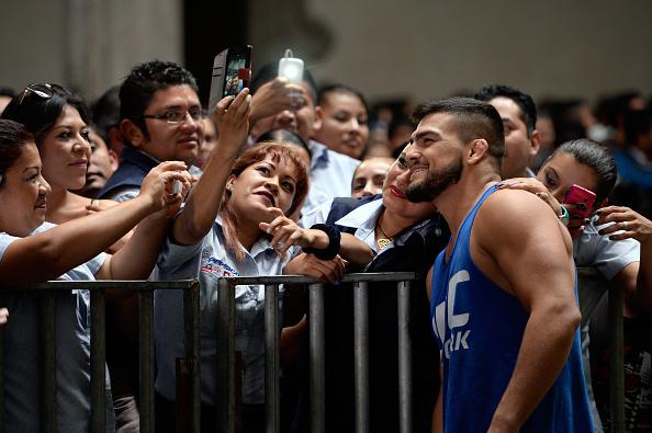 MEXICO CITY, MEXICO - NOVEMBER 12: Kelvin Gastelum interacts with fans during the UFC 180 open workouts at the Interactive Museum of Economics on November 12, 2014 in Mexico City, Mexico. (Photo by Jeff Bottari/Zuffa LLC/Zuffa LLC via Getty Images)
