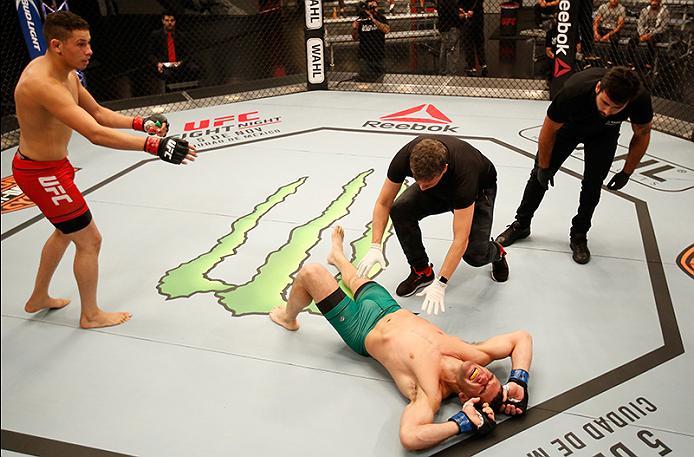 BUENOS AIRES, ARGENTINA - MAY 28: (R-L) Javier Ganin lays on the ground in pain after facing Martin Bravo during the filming of The Ultimate Fighter Latin America: Team Liddell vs Team Griffin on May 28, 2016 in Buenos Aires, Argentina. (Photo by Gabriel