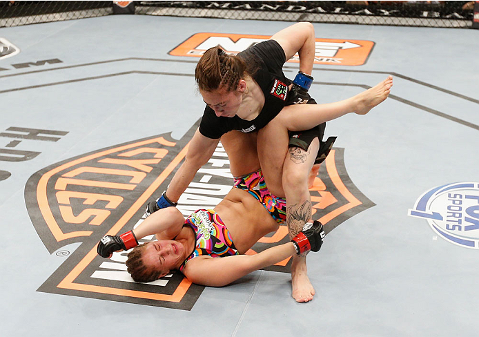 LAS VEGAS, NV - JULY 06:  Alexis Dufresne (top) punches Sarah Moras in their women's bantamweight fight during the Ultimate Fighter Finale inside the Mandalay Bay Events Center on July 6, 2014 in Las Vegas, Nevada.  (Photo by Josh Hedges/Zuffa LLC/Zuffa L