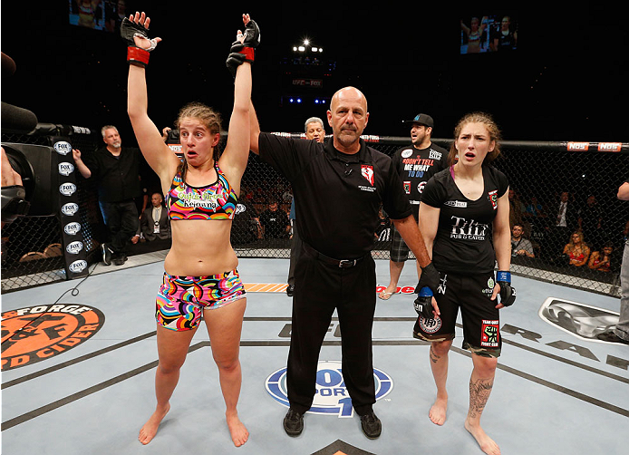 LAS VEGAS, NV - JULY 06:  (L-R) Sarah Moras celebrates after defeating Alexis Dufresne in their women's bantamweight fight during the Ultimate Fighter Finale inside the Mandalay Bay Events Center on July 6, 2014 in Las Vegas, Nevada.  (Photo by Josh Hedge