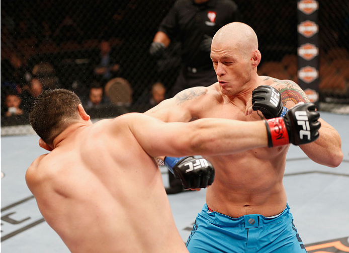 LAS VEGAS, NV - JULY 06: (R-L) Daniel Spohn and Patrick Walsh exchange punches in their light heavyweight fight during the Ultimate Fighter Finale inside the Mandalay Bay Events Center on July 6, 2014 in Las Vegas, Nevada. (Photo by Josh Hedges/Zuffa LL
