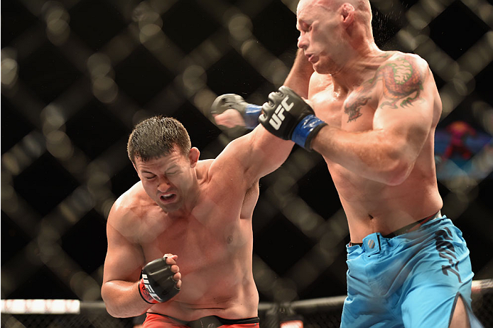 LAS VEGAS, NV - JULY 06: (L-R) Patrick Walsh and Daniel Spohn exchange punches in their light heavyweight fight during the Ultimate Fighter Finale inside the Mandalay Bay Events Center on July 6, 2014 in Las Vegas, Nevada. (Photo by Jeff Bottari/Zuffa L