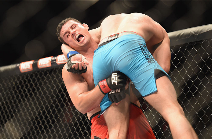 LAS VEGAS, NV - JULY 06:  (L-R) Patrick Walsh takes down Daniel Spohn in their light heavyweight fight during the Ultimate Fighter Finale inside the Mandalay Bay Events Center on July 6, 2014 in Las Vegas, Nevada.  (Photo by Jeff Bottari/Zuffa LLC/Zuffa L