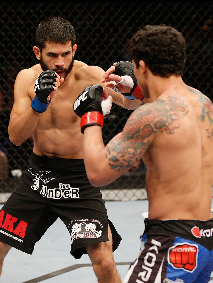 LAS VEGAS, NV - JULY 06: (L-R) Juan Maneul Puig Carreon squares off with Adriano Martins in their lightweight fight during the Ultimate Fighter Finale inside the Mandalay Bay Events Center on July 6, 2014 in Las Vegas, Nevada. (Photo by Josh Hedges/Zuff