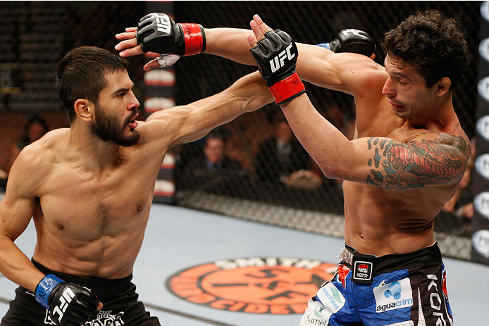 LAS VEGAS, NV - JULY 06: (L-R) Juan Maneul Puig Carreon punches with Adriano Martins in their lightweight fight during the Ultimate Fighter Finale inside the Mandalay Bay Events Center on July 6, 2014 in Las Vegas, Nevada. (Photo by Josh Hedges/Zuffa LL