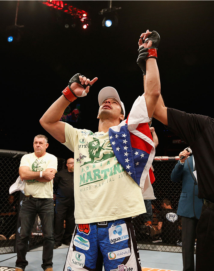 LAS VEGAS, NV - JULY 06:  Adriano Martins celebrates after knocking out Juan Maneul Puig Carreon in their lightweight fight during the Ultimate Fighter Finale inside the Mandalay Bay Events Center on July 6, 2014 in Las Vegas, Nevada.  (Photo by Josh Hedg