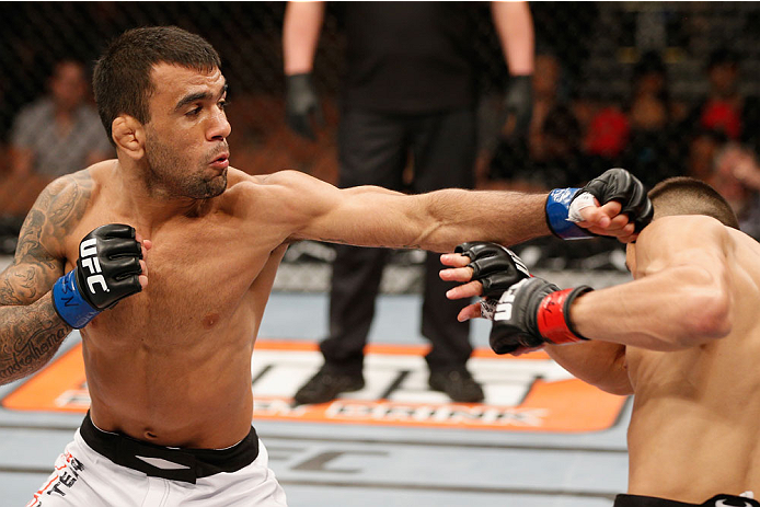 LAS VEGAS, NV - JULY 06:  (L-R) Leandro Issa punches Jumabieke Tuerxun in their bantamweight fight during the Ultimate Fighter Finale inside the Mandalay Bay Events Center on July 6, 2014 in Las Vegas, Nevada.  (Photo by Josh Hedges/Zuffa LLC/Zuffa LLC vi